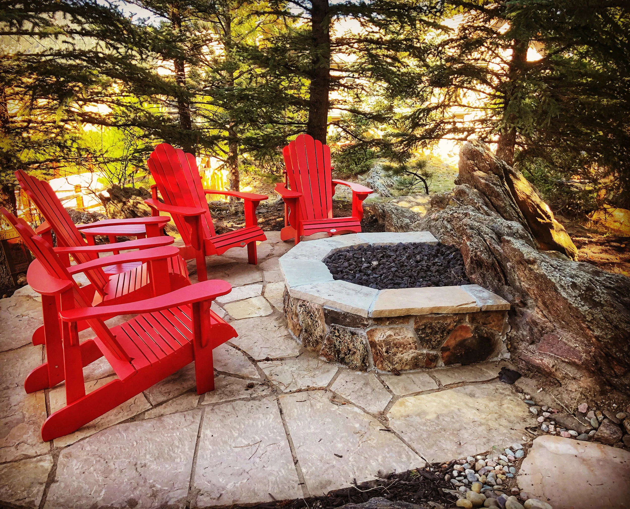 natural stone fire pit with boulder wall