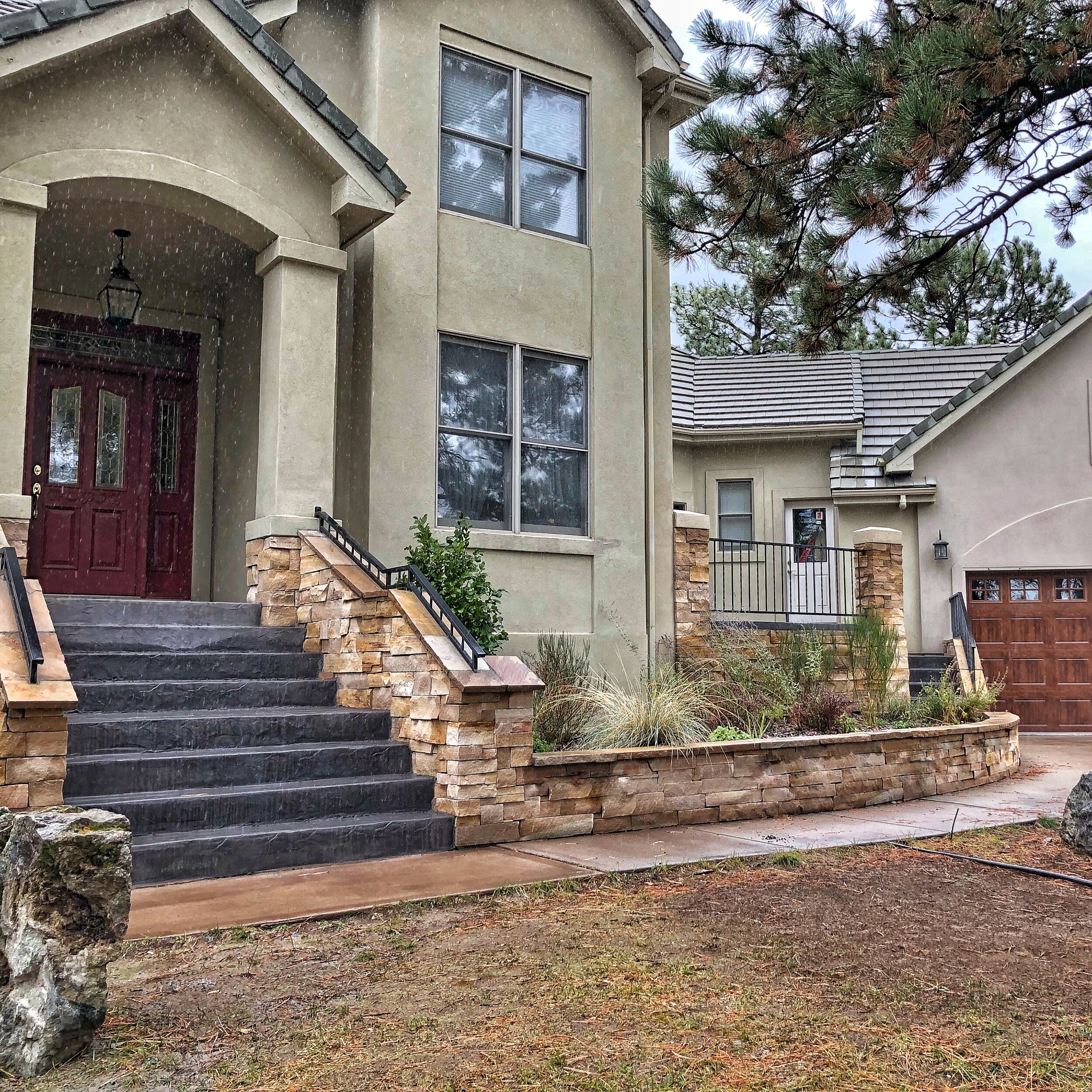 custom stone walkway and wall with concrete steps