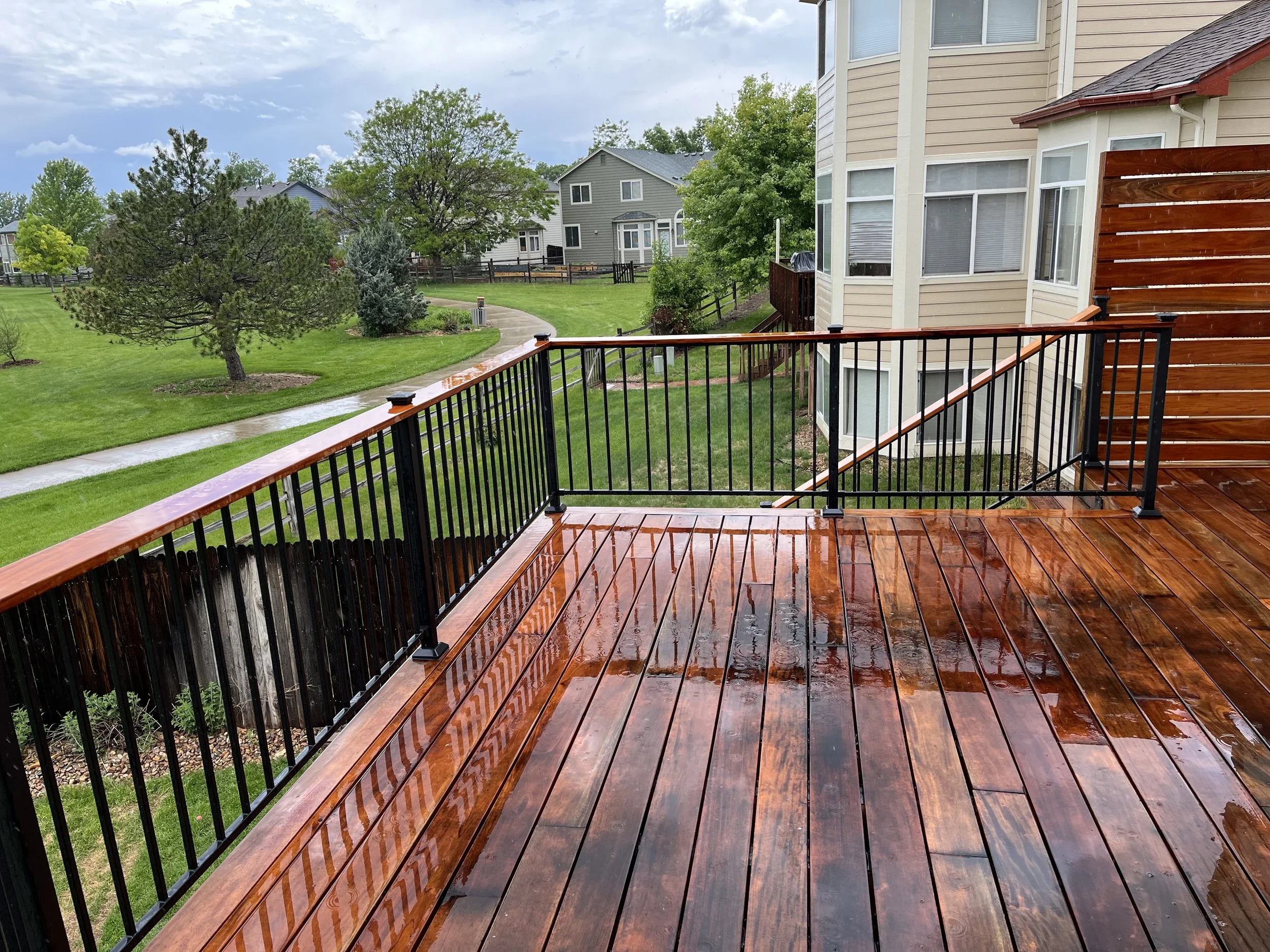 custom deck with staircase and metal railings