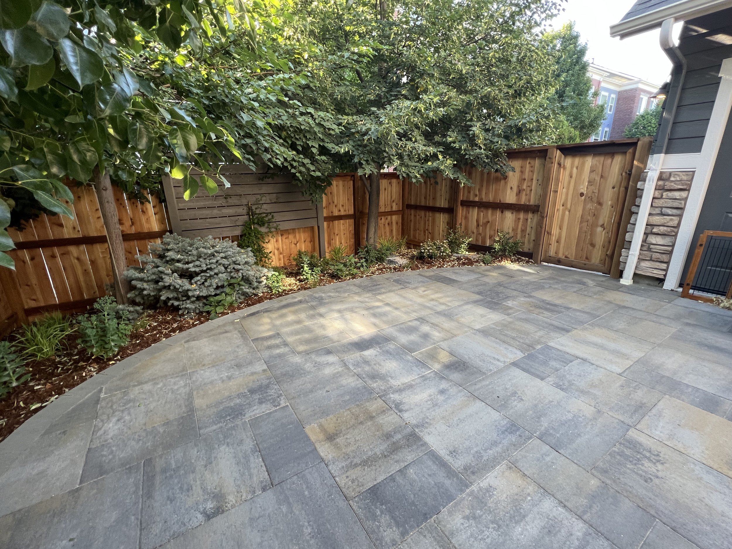beautiful paver patio surrounded by garden