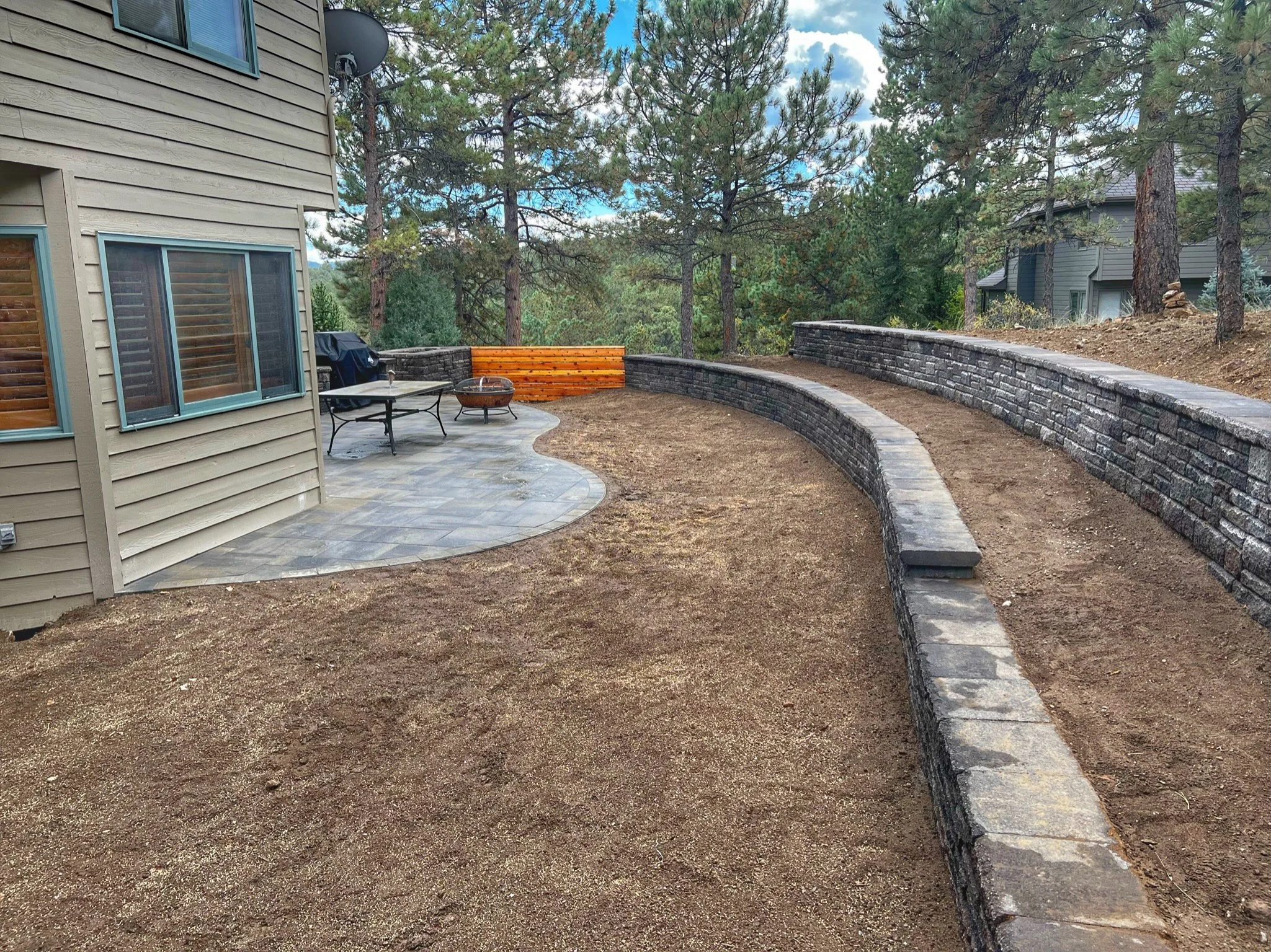 multi level stone retaining wall backyard