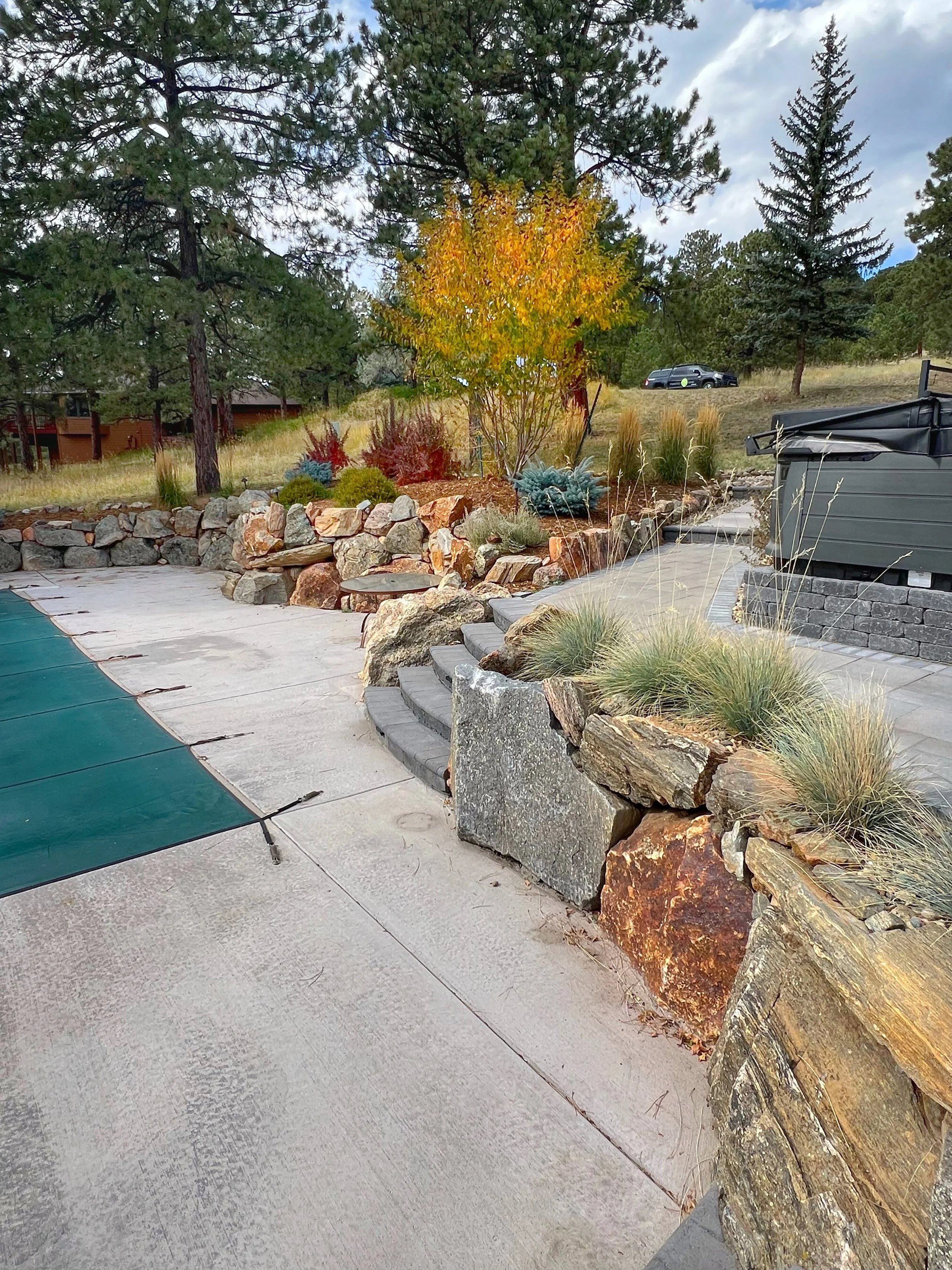 custom boulder retaining wall for pool deck