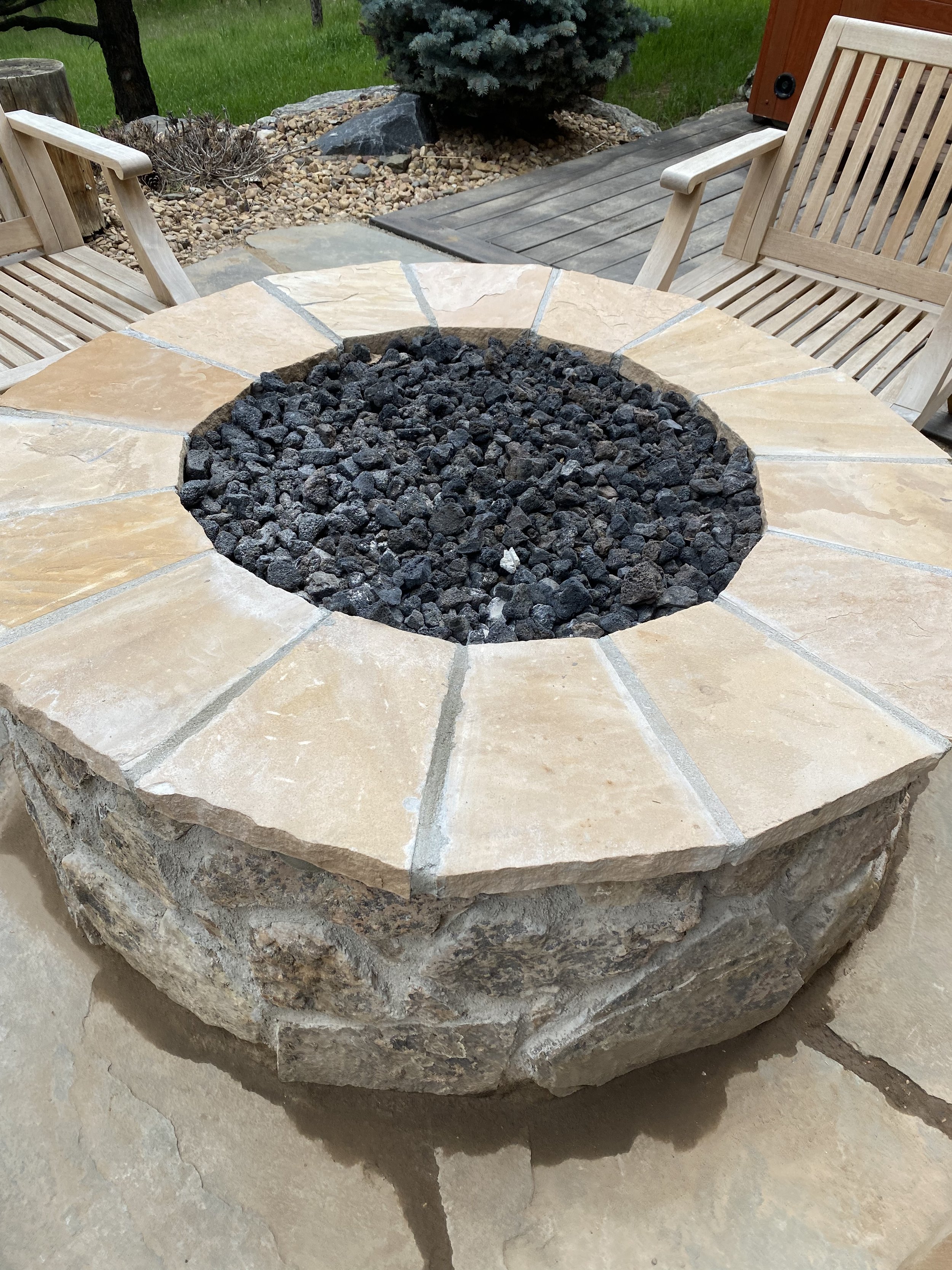 natural light stone fire pit with dark rock
