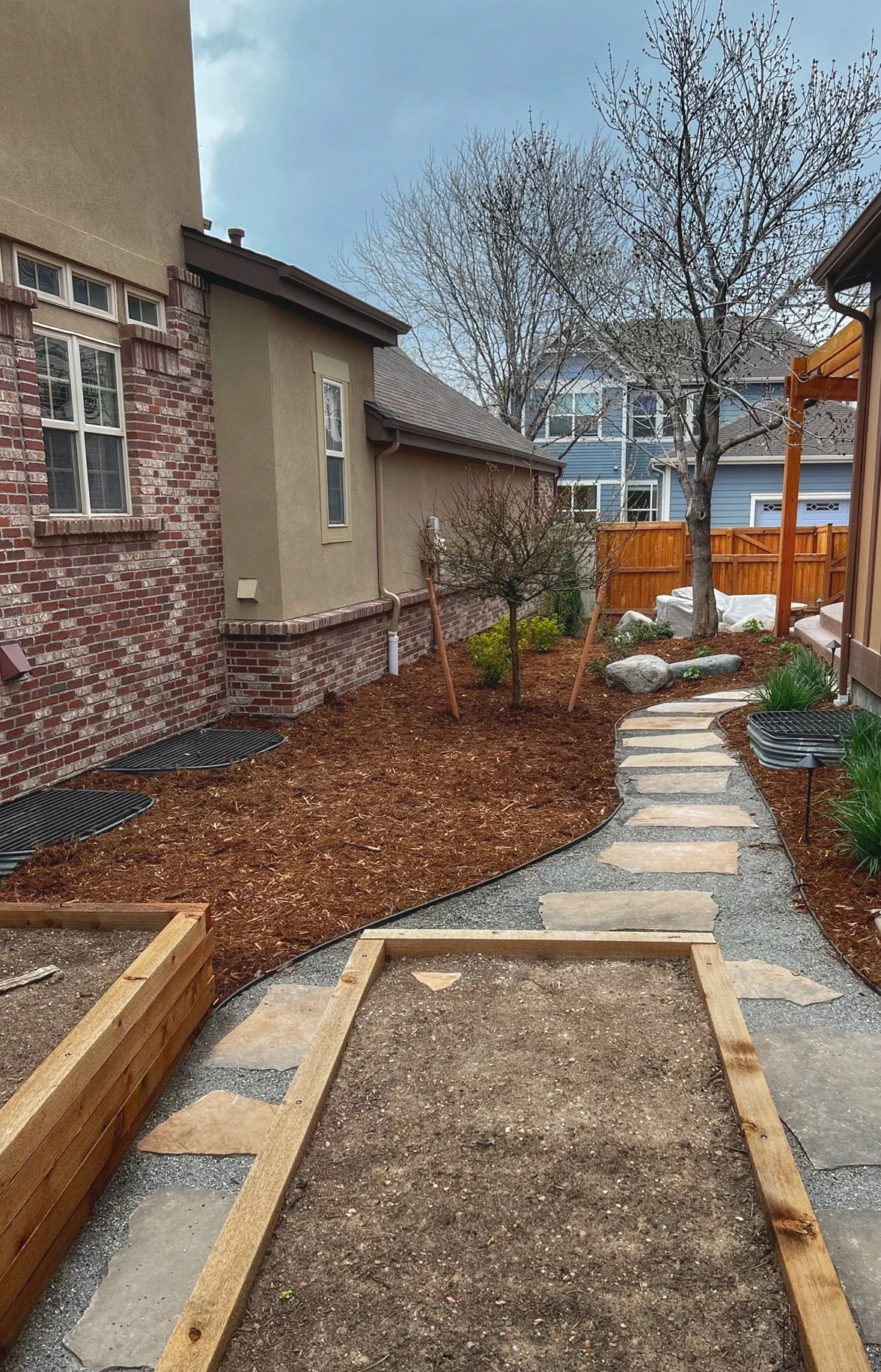 cedar plant boxes with stone walkway