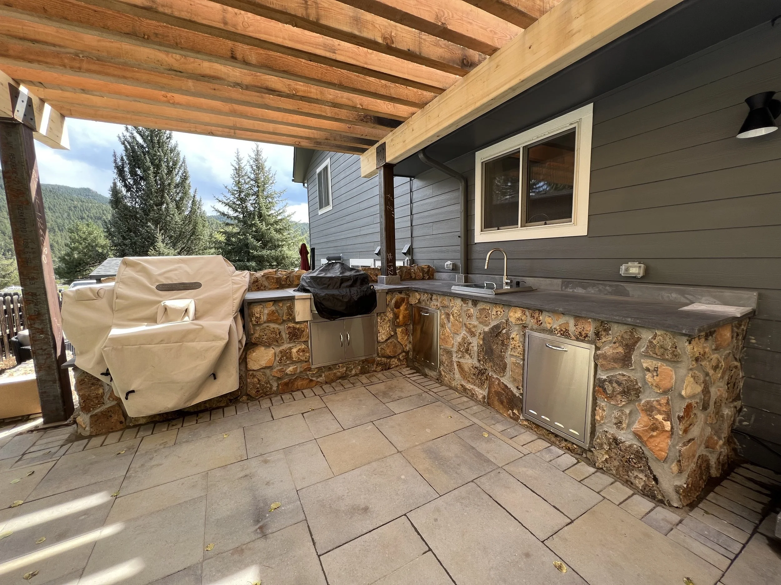 natural looking outdoor kitchen with custom stone and concrete countertop