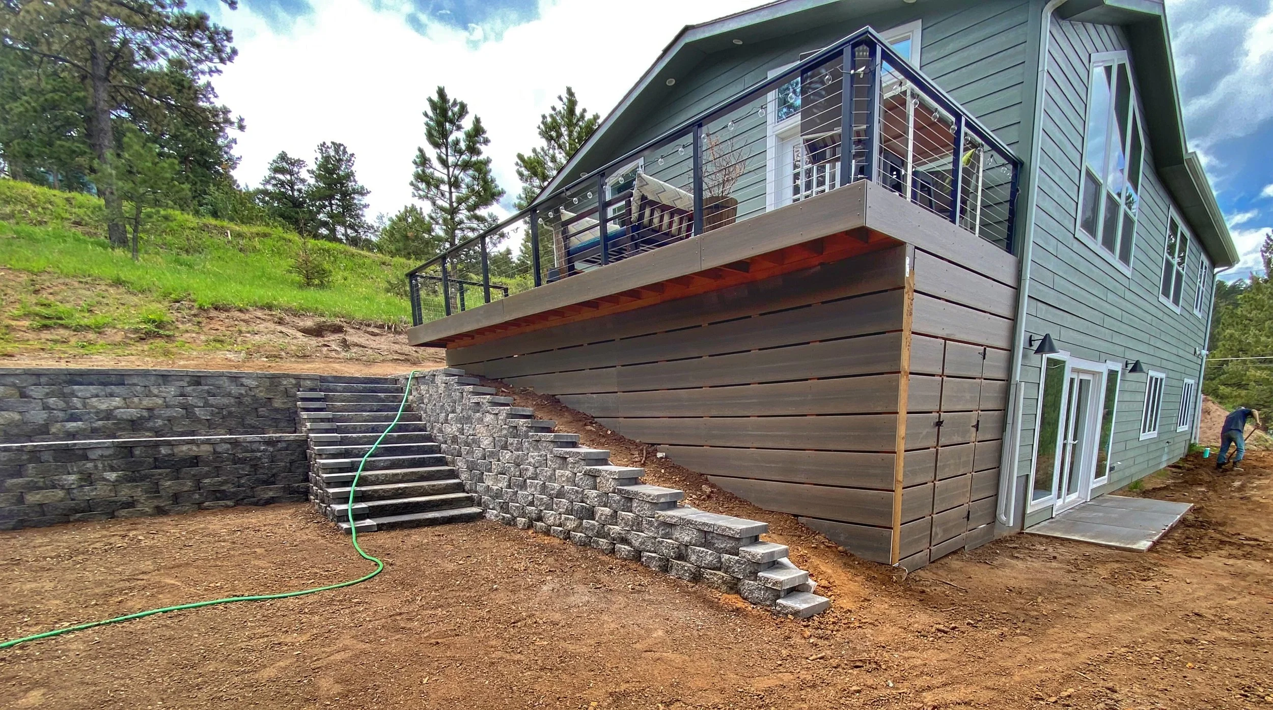 large stone staircase with retaining wall on sloped land