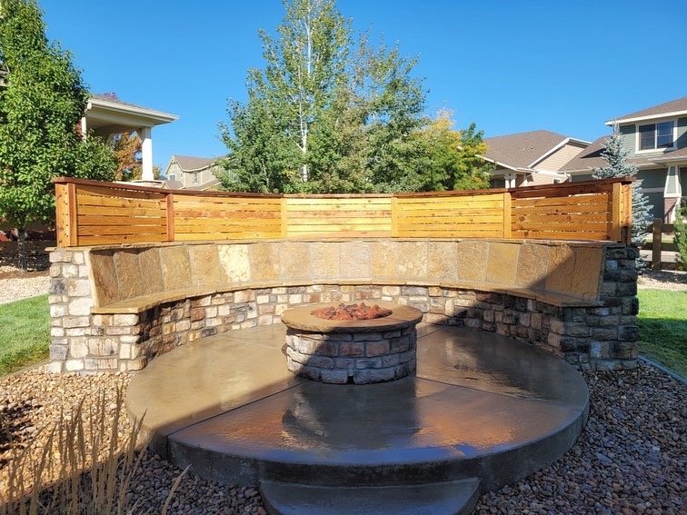 custom outdoor fire pit with natural stone bench seating