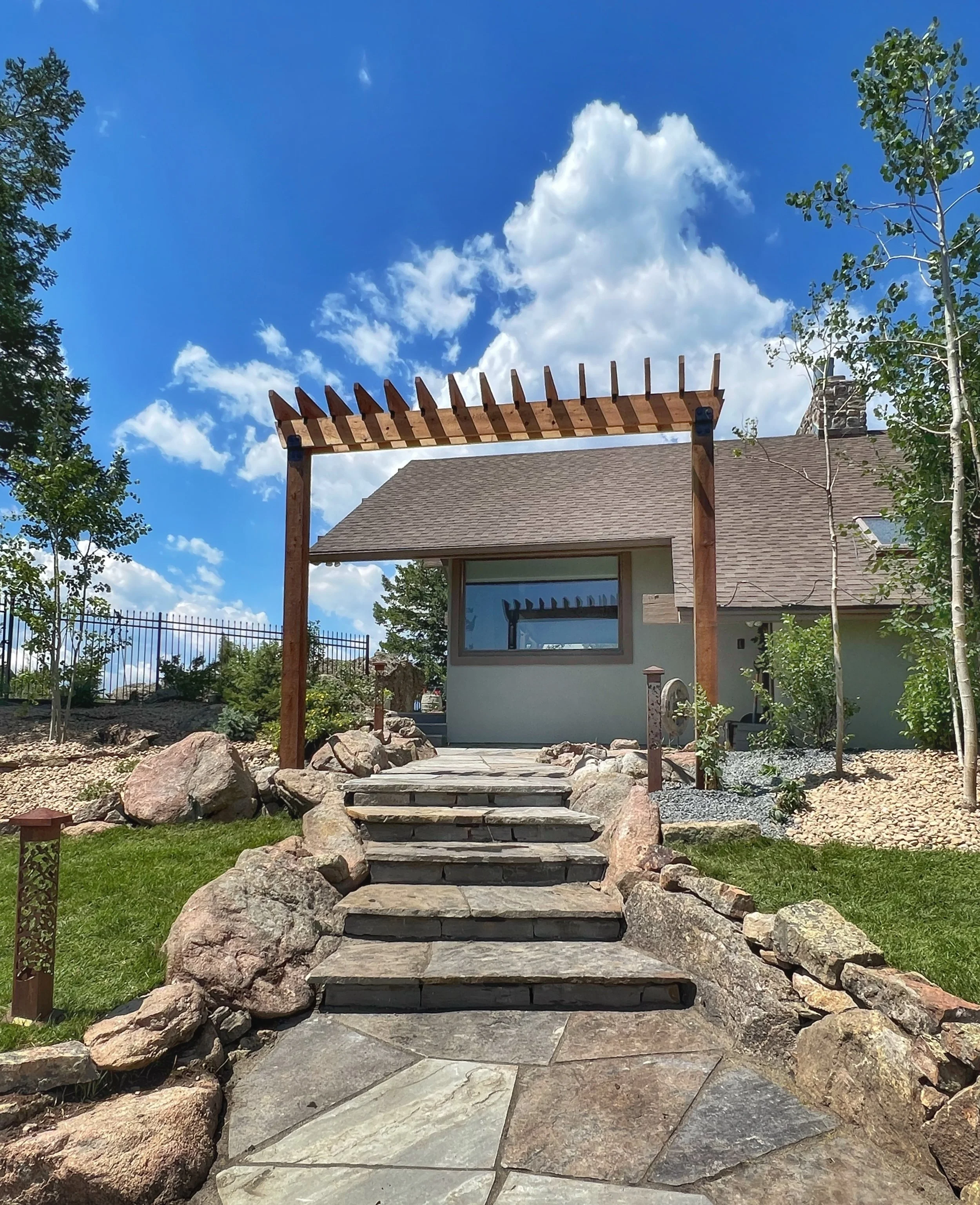 flagstone patio and stairs outlined with boulders