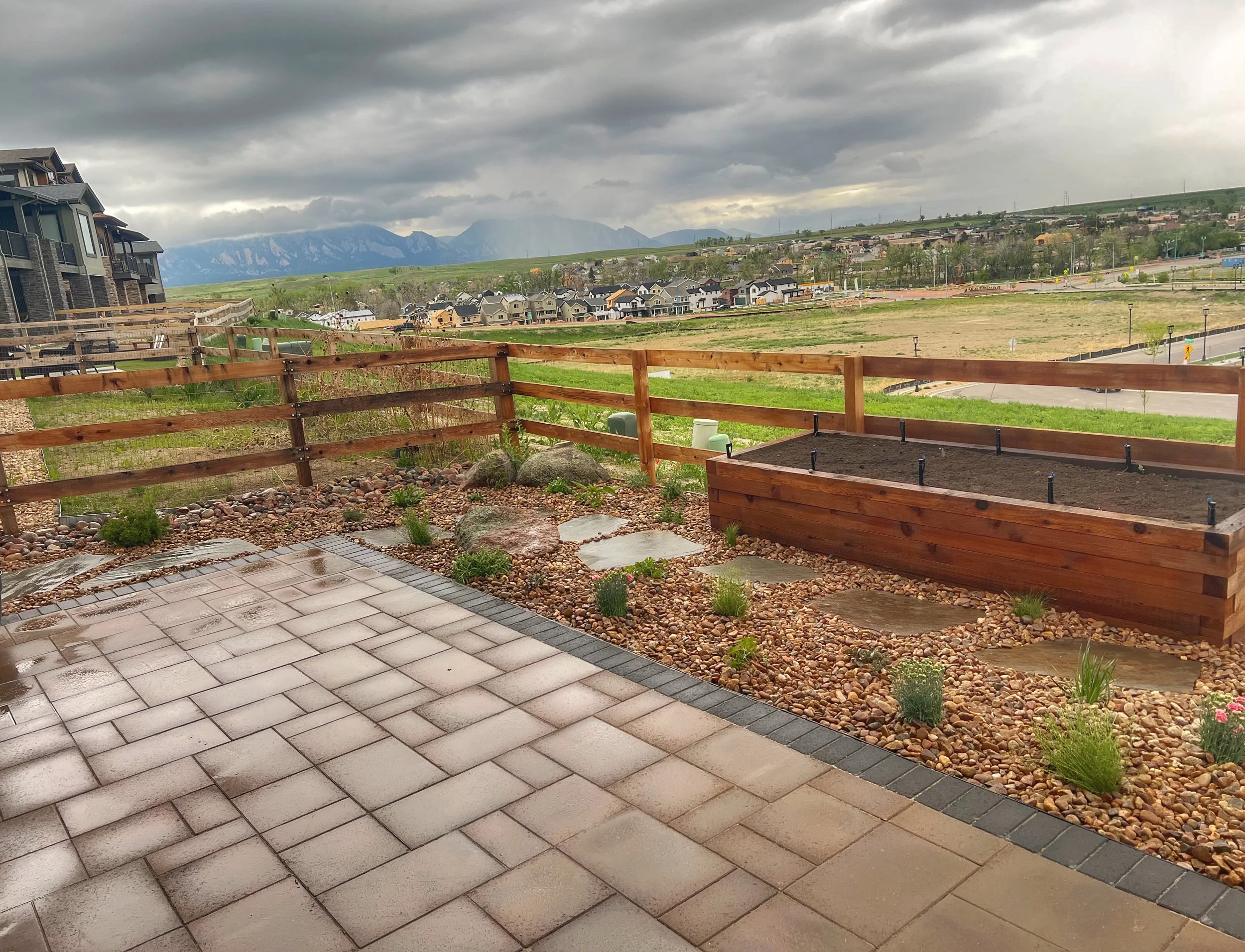 custom paver patio with rock garden and cedar garden box