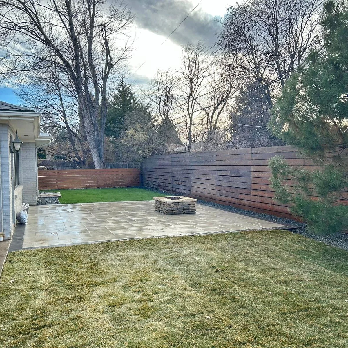 square paver patio with custom wood fence