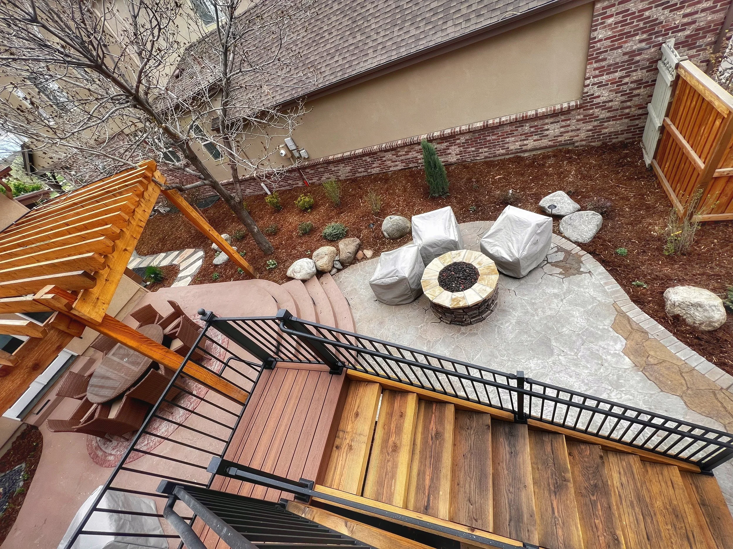 beautiful multi-pitch custom stone patio with fire pit