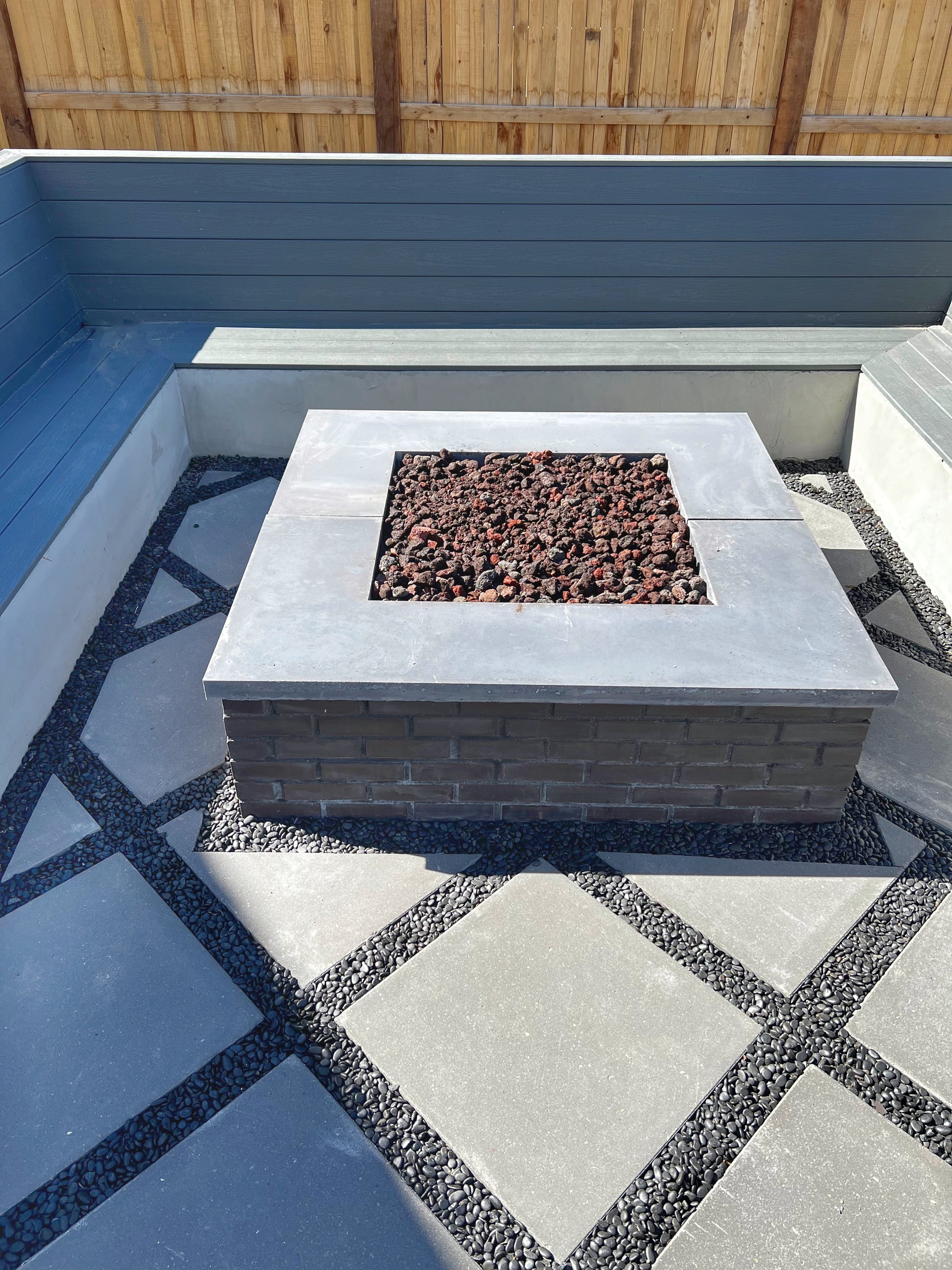 square paver patio with brick fire feature