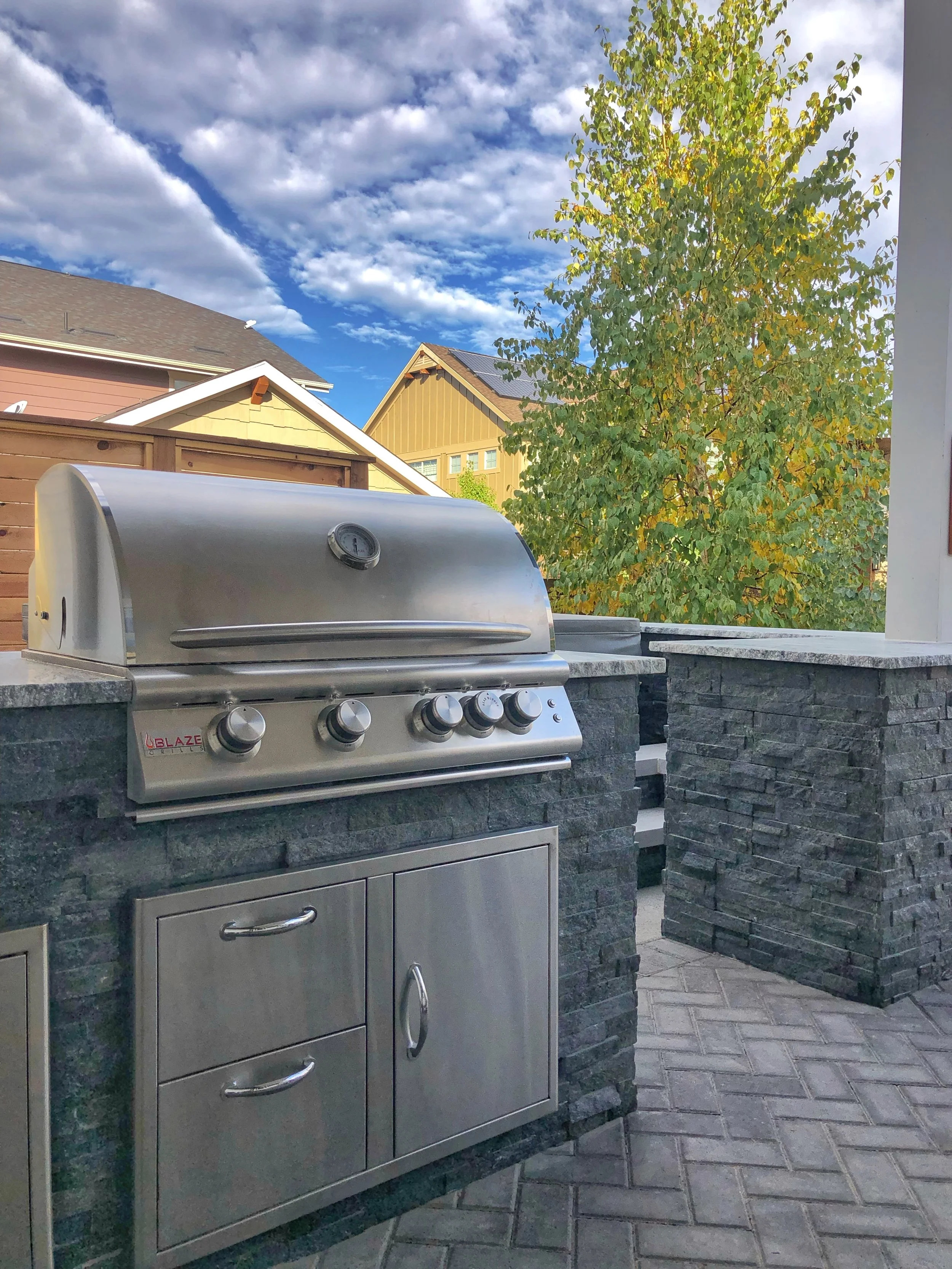 grey stone outdoor kitchen stainless steel