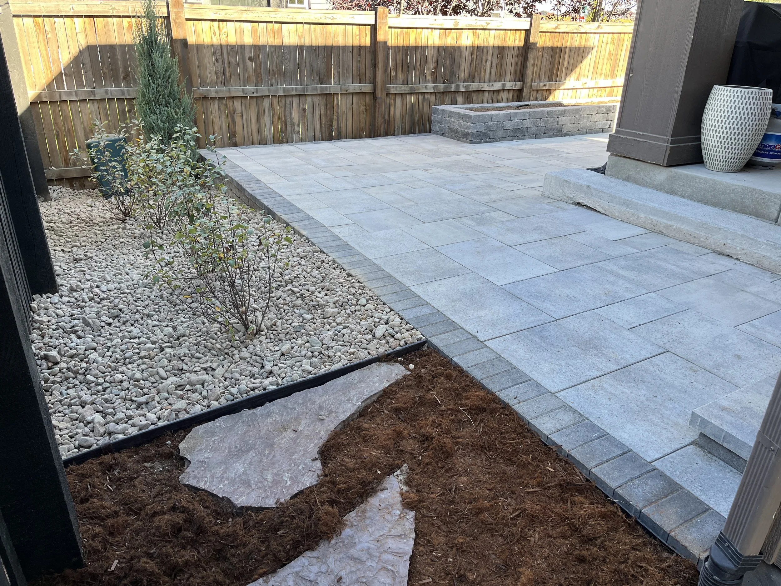 paver patio with rock garden and flagstone steppers
