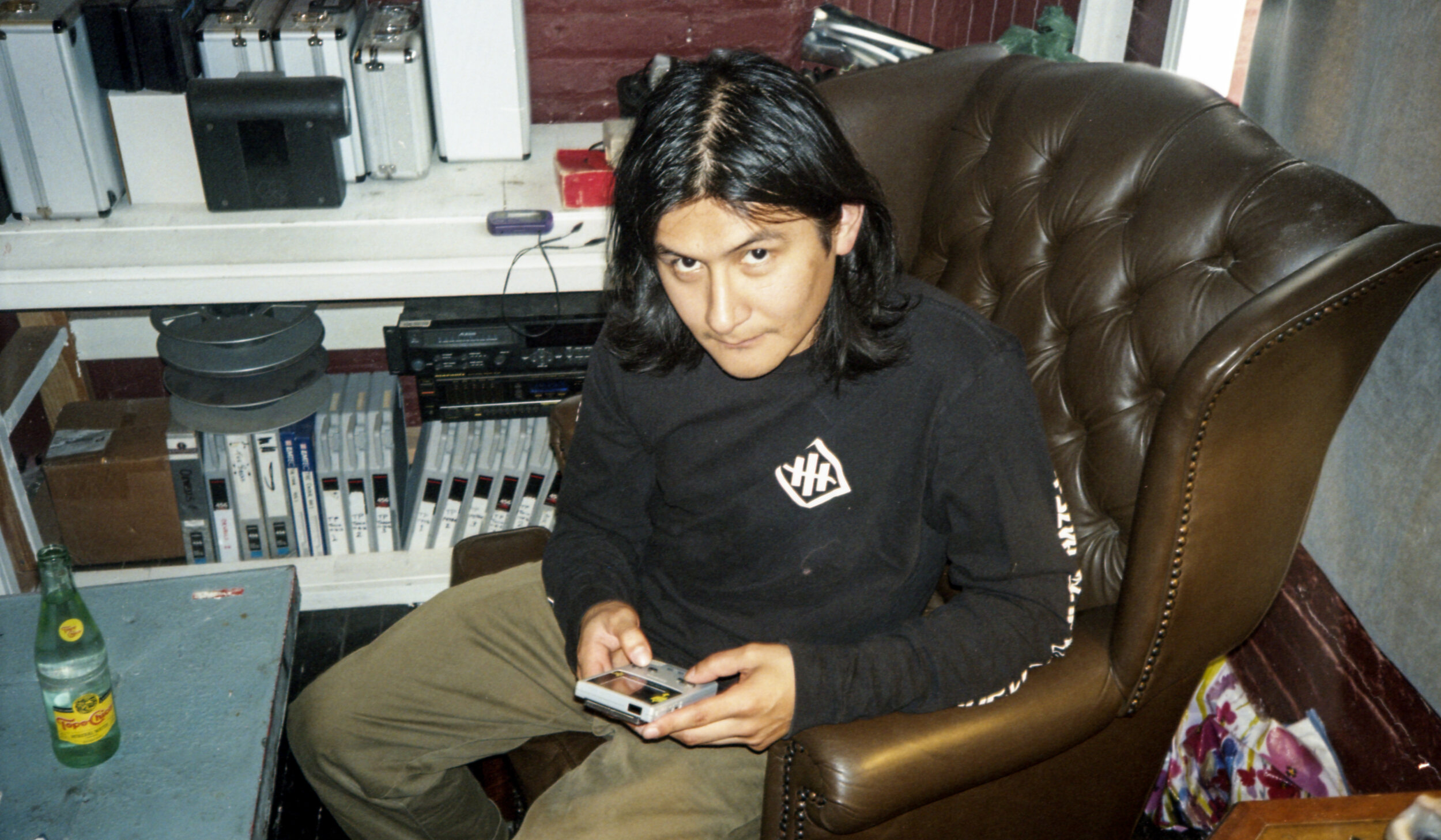 Drummer Alexis Castillo trying to get a game boy working.