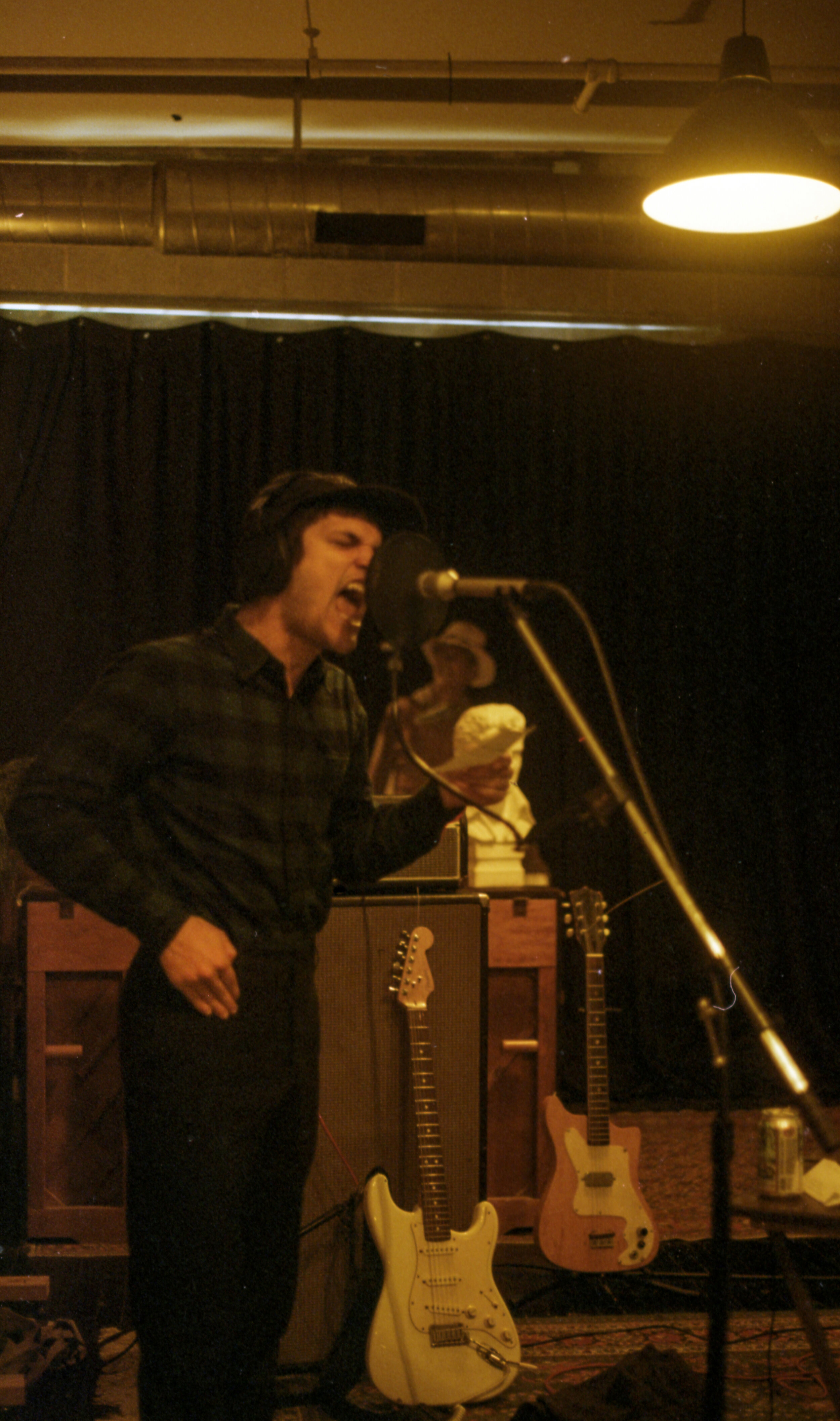 Singer/guitarist Danny Gomez laying down a vocal track in the studio.