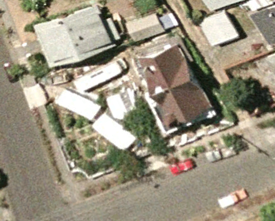 July 2004. HOLY SHIT! The RV is in a different spot. And the spot it's in is where the garage will be in the coming year. And, it looks like there are 3 temporary structures. Also, the roof of the house is brown. 2005 is going to be a big year at the Going Queen. Lots of changes are coming. Also, notice the truck parked behind the red car. The bed of that truck is a lot less rusted that it will be in the coming years. Scroll back up to watch the truck bed gain character.