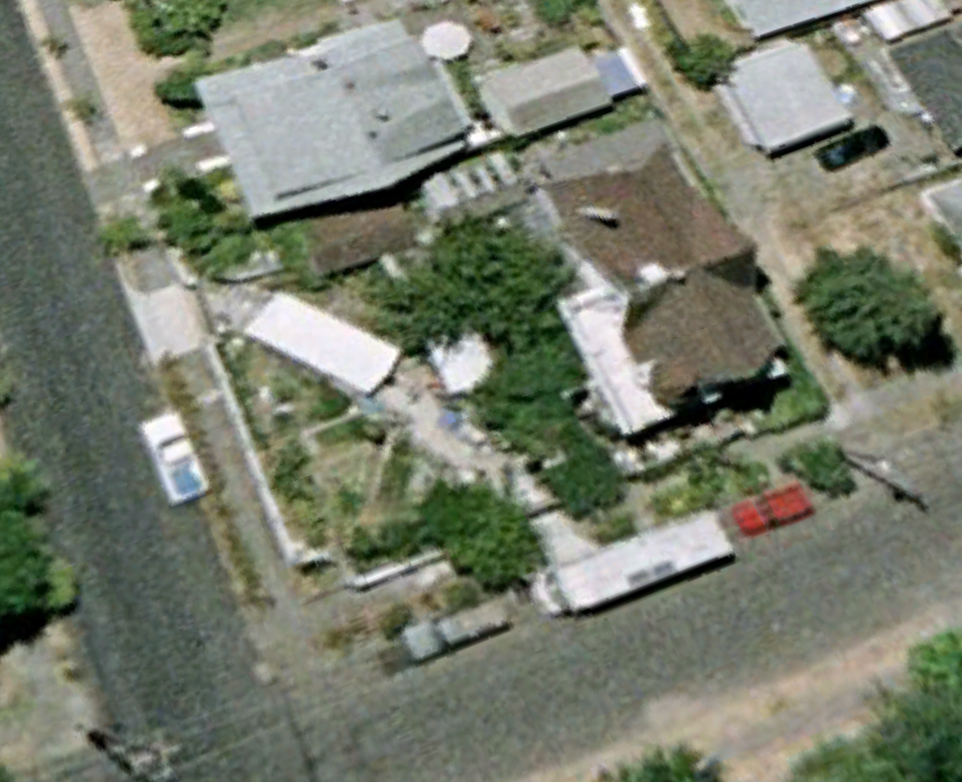 July 2003. Well, the RV is on the street. There is a small shed where the garage will one day be. Notice that the shed goes away in 2004 and is then replaced in 2005 with the big garage. Maybe is collapsed? Also, there is a BIG tree in the the yard in front of the house. That gets cut down in the next year. You might also notice that there is a skylight near the chimney in the upper left corder of the roof in all the other pictures. Jim must have put that skylight in sometime between 2003 and 2004.