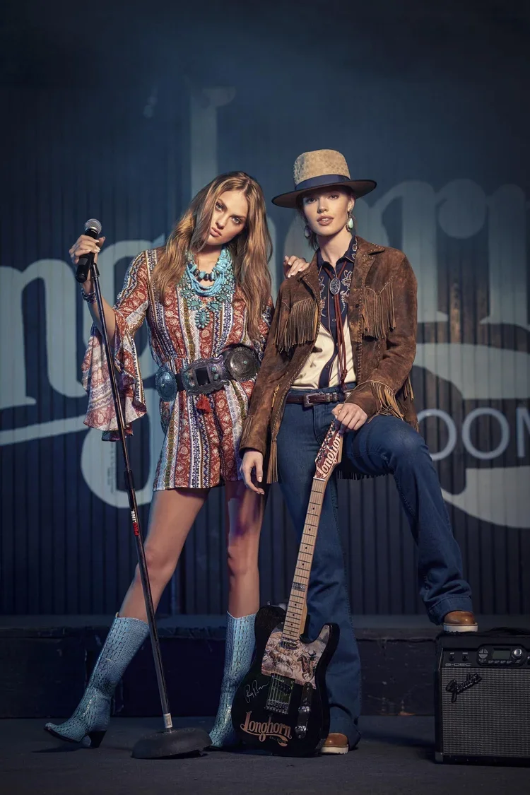 Two fashion models with guitar on stage