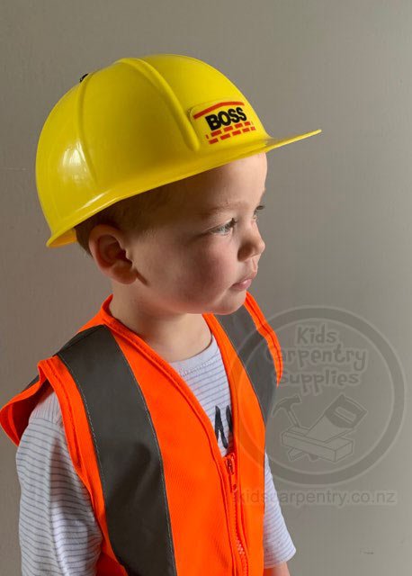 Child sized yellow hard hat with Boss sticker worn by child with high visibility safety vest