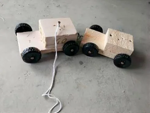 Wooden cars made by kids using plastic craft wheels