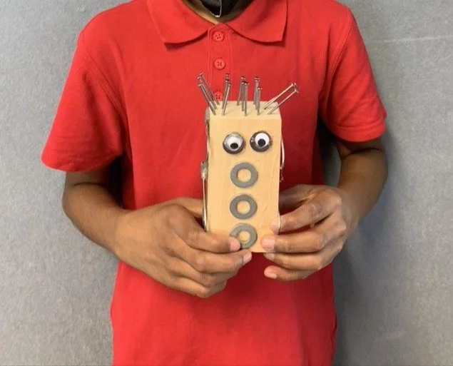 Kids making robots from upcycled and recycled materials at school