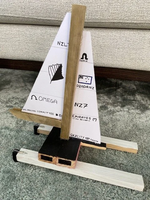 Wooden racing yacht model inspired by America's Cup yachts made by children from craft wood