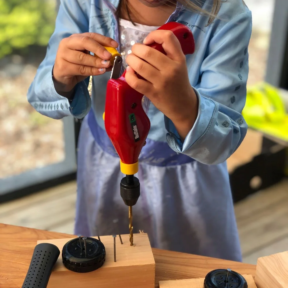 Young Girl Using Real Kids Hand Drill to Create Pilot Hole in Wood