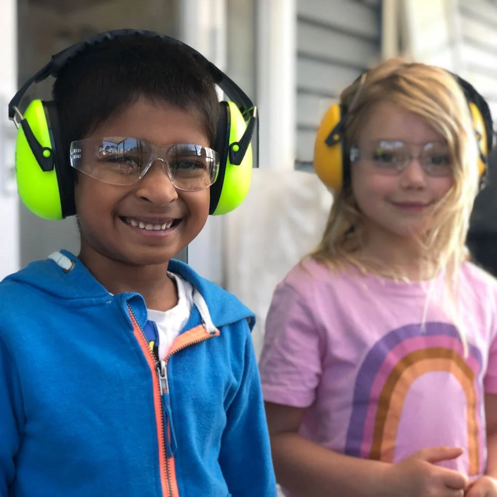 Primary school students wearing safety glasses and earmuffs during hands-on learning