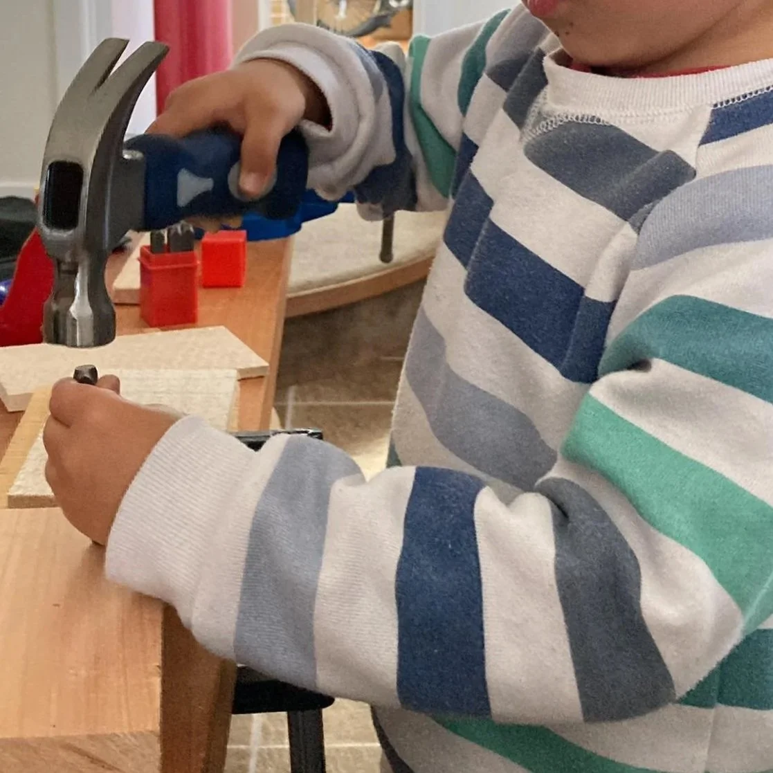 Child using number punches to explore maths, counting, sequencing and hands-on numeracy skills