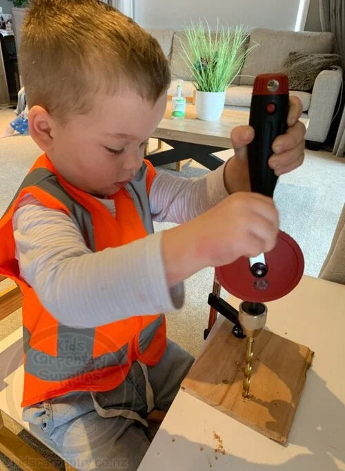 Child Practicing Drilling Skills in Woodworking Activity
