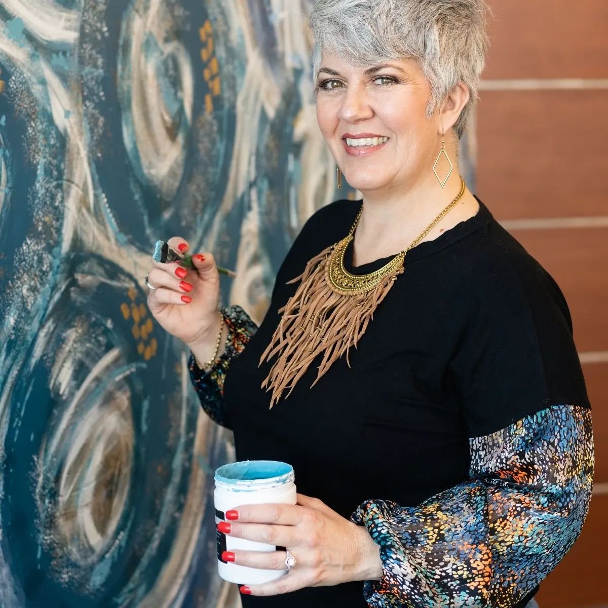  Fergus Falls artist, Patricia Wahl, poses with the mural completed for Lake Region Healthcare as part of their ‘For You. Always’ campaign. 