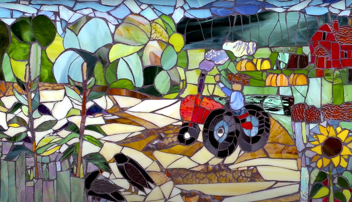  A tractor is depicted with mosaic sections of bright colors. 