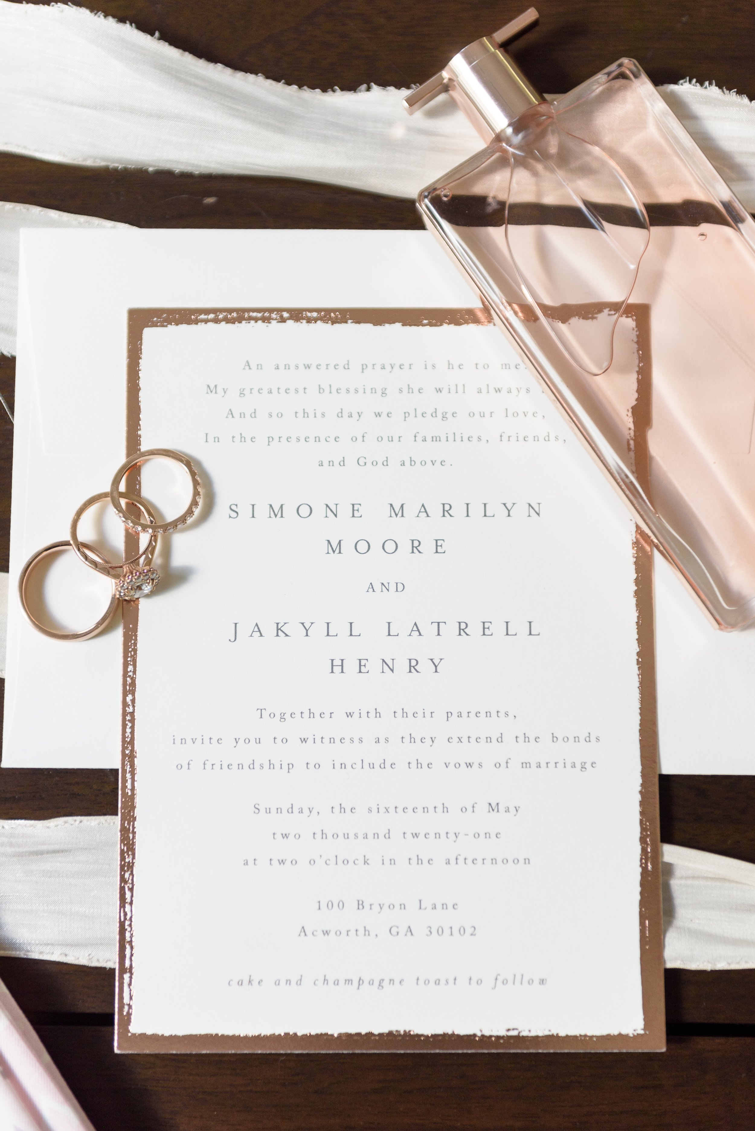 Wedding day details with wedding rings, wedding invitation, and chanel perfume captured on wedding day