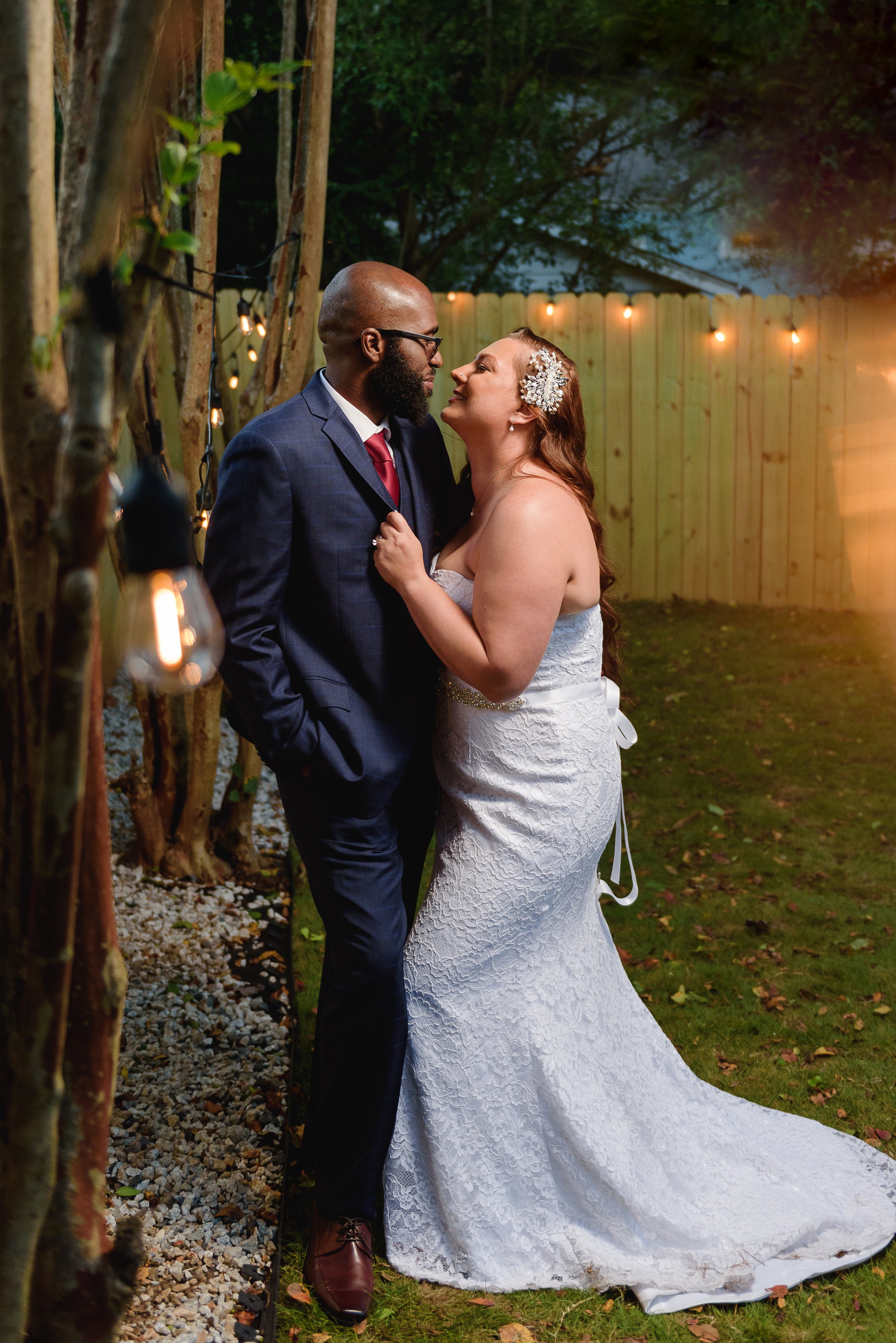 Newlywed Bride and Groom take a photo together at their backyard intimate wedding ceremony in Hapeville, Georgia