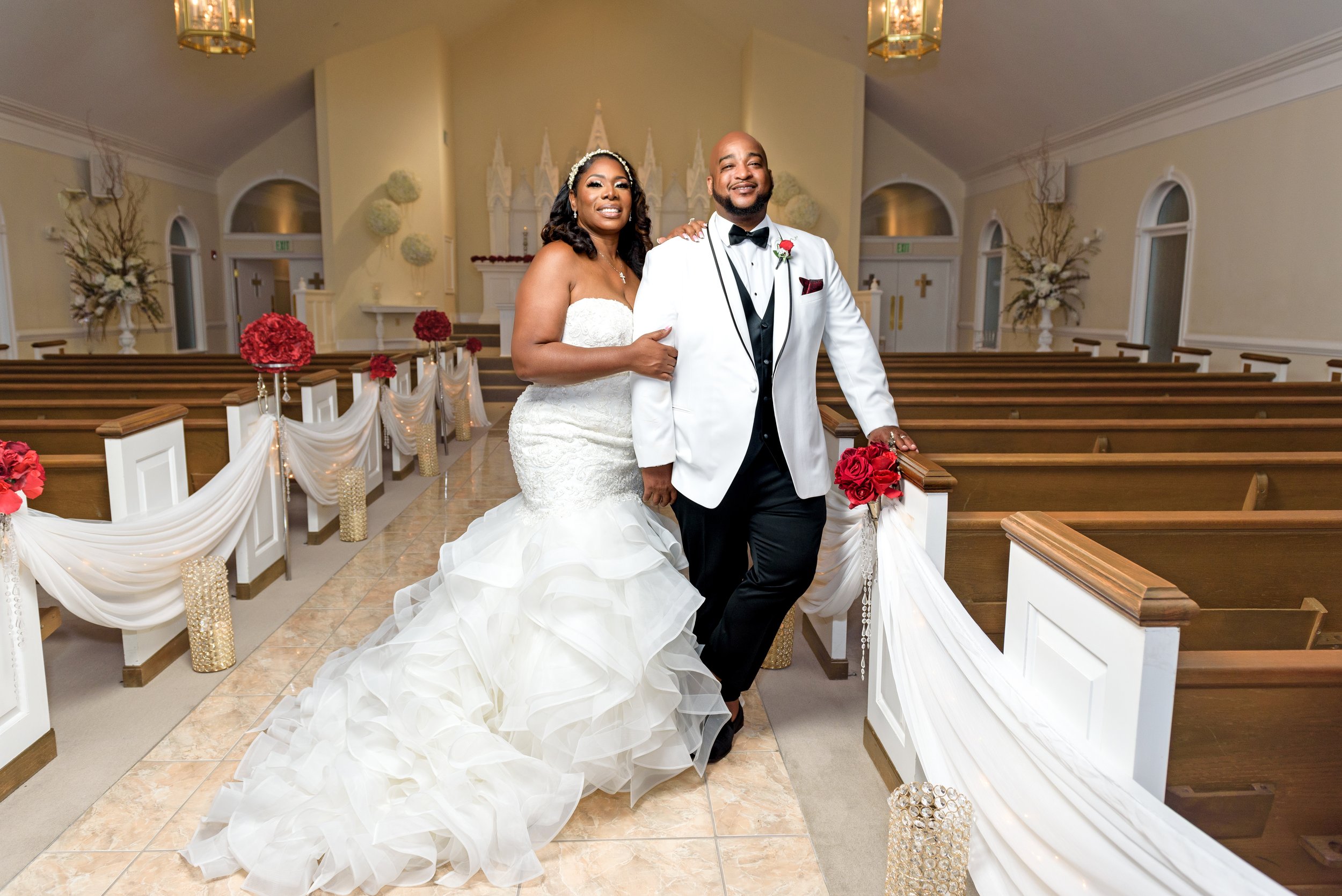 Bride and Groom Stand in the beautifully decorated wedding ceremony area at Pristine Chapel Lakeside in Jonesboro, GA