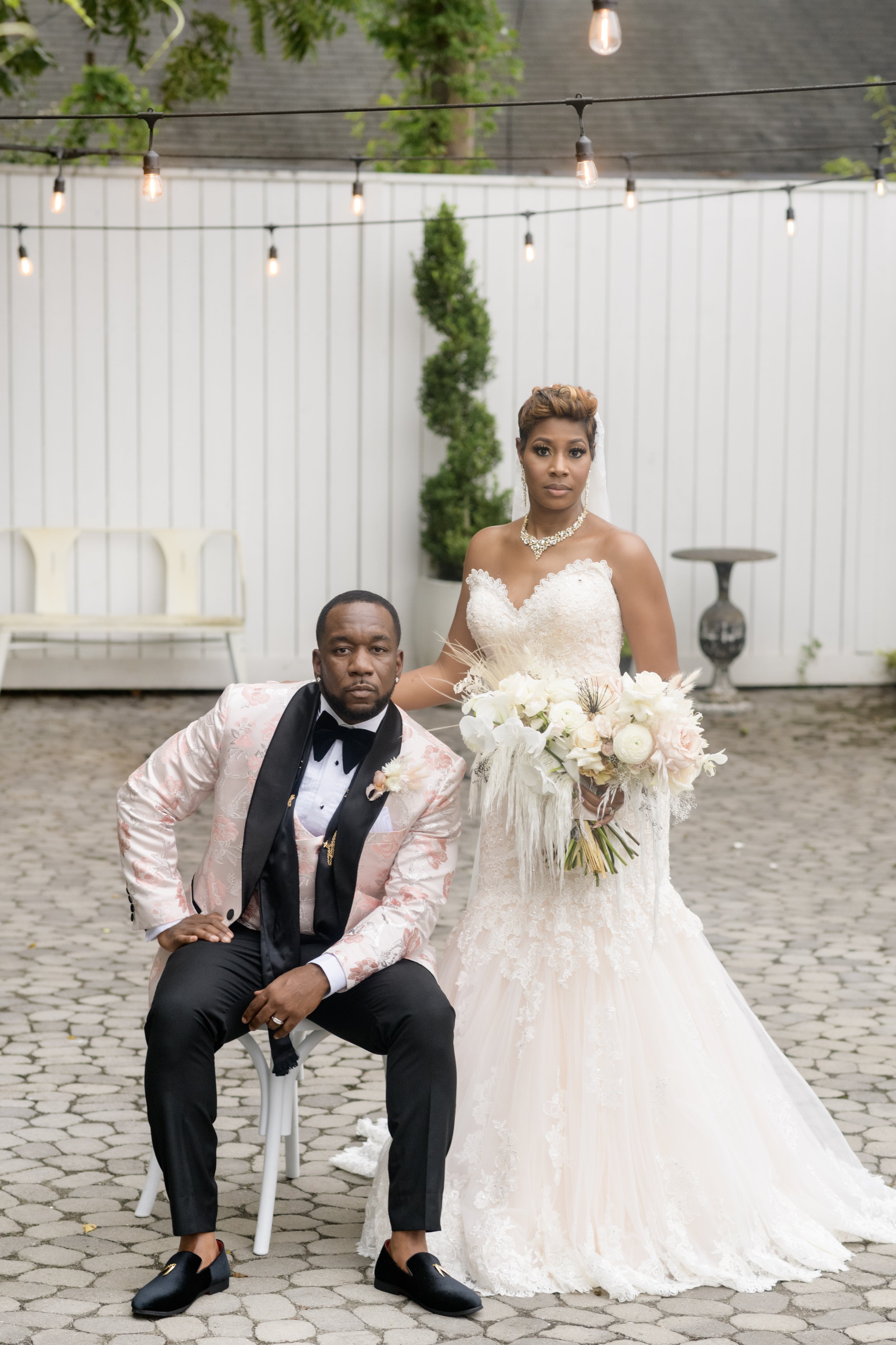 Newlywed Bride and Groom pose in the courtyard of their Atlanta wedding venue moments after being married