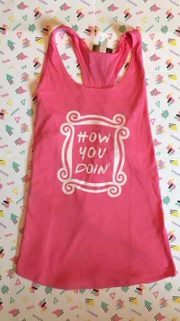 Wear the wise words of Mr. Tribbiani by grabbing the How Are You Doin’ Inspiration 90s Tank for $24!