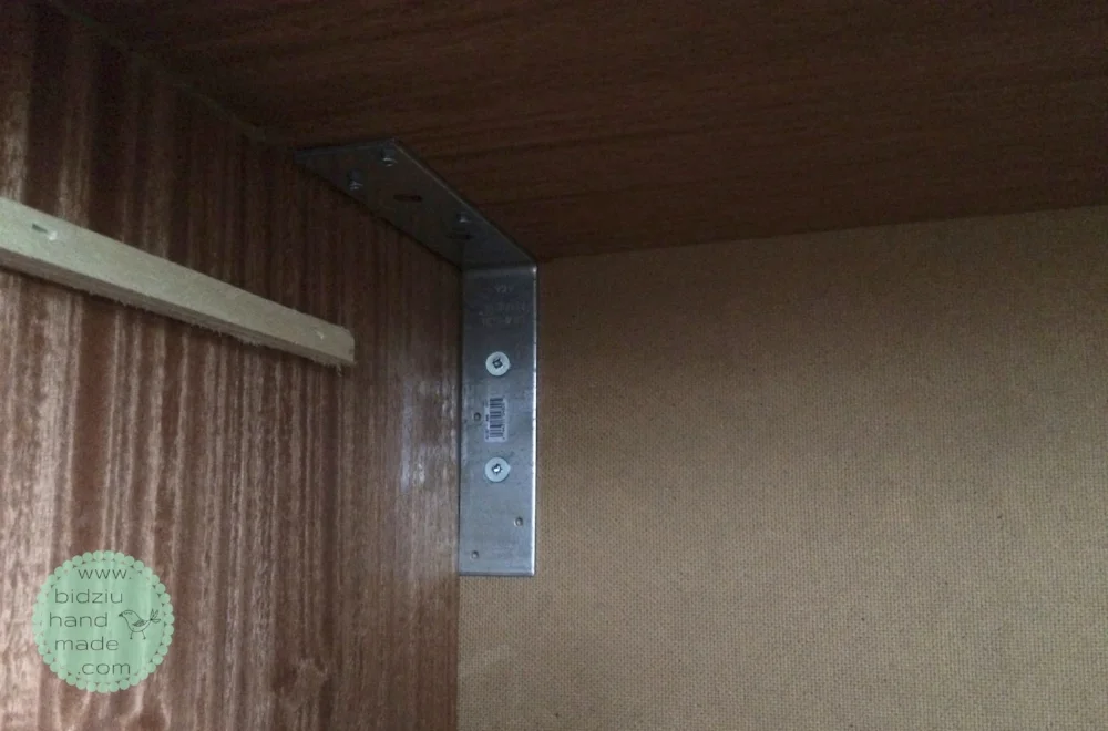 Dresser attached to the wall via L-brackets. L-brackets were attached in each corner and in the centre of the unit on the inside of the unit, and also underneath the dresser.