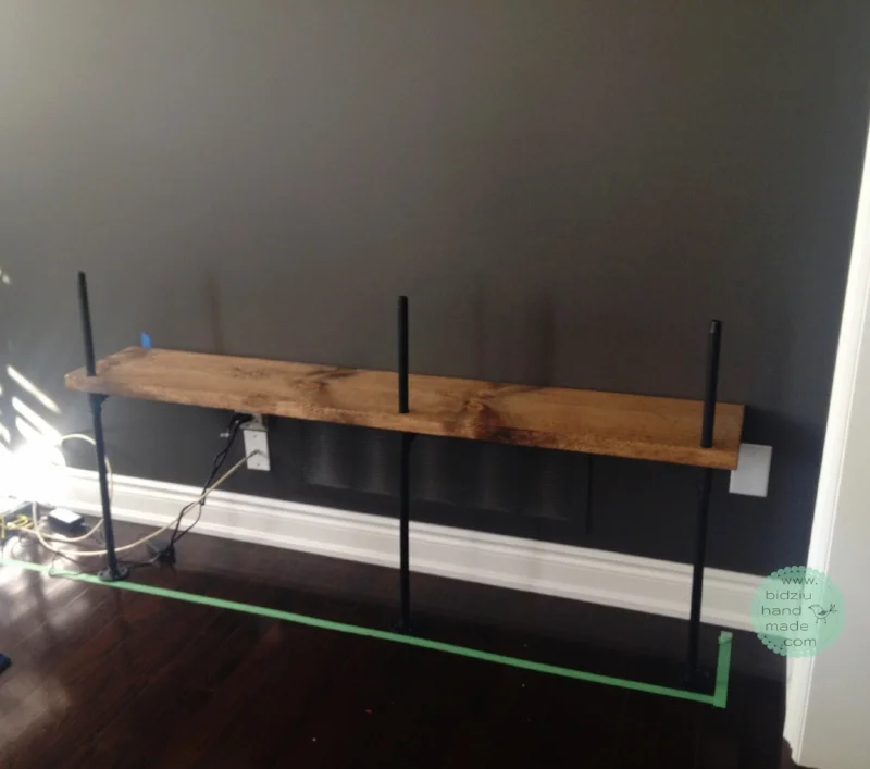 The beginning of building the unit. Bottom right shelf placed onto vertical pipes. 