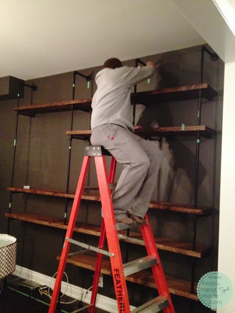 Assembly complete. Here my handsome helper is screwing the top flanges into the wall.