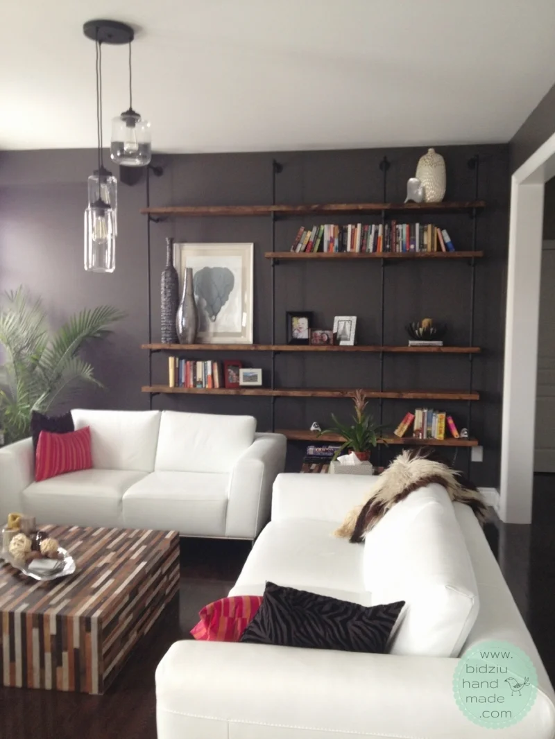 The shelving unit really transforms the room. What used to be a large, bare wall, is now a unique decorative piece that not only adds visual interest, but functionality to the space.