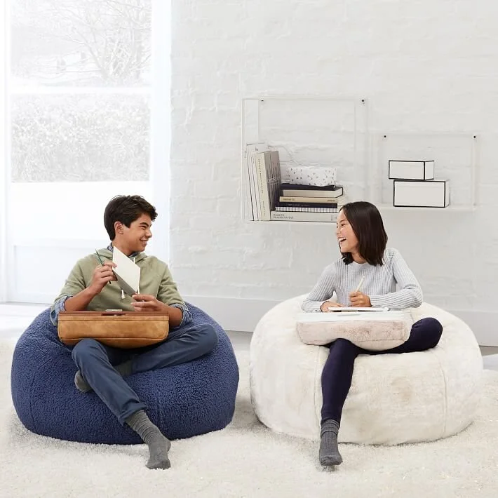  Boy and girl sitting on bean bag chairs  