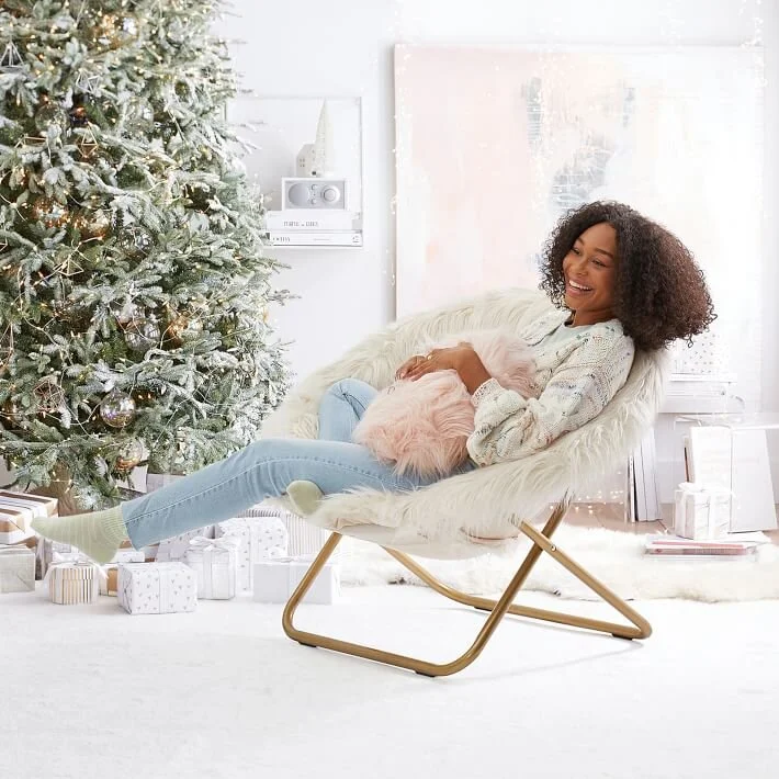  Girl on chair in front of Christmas tree 