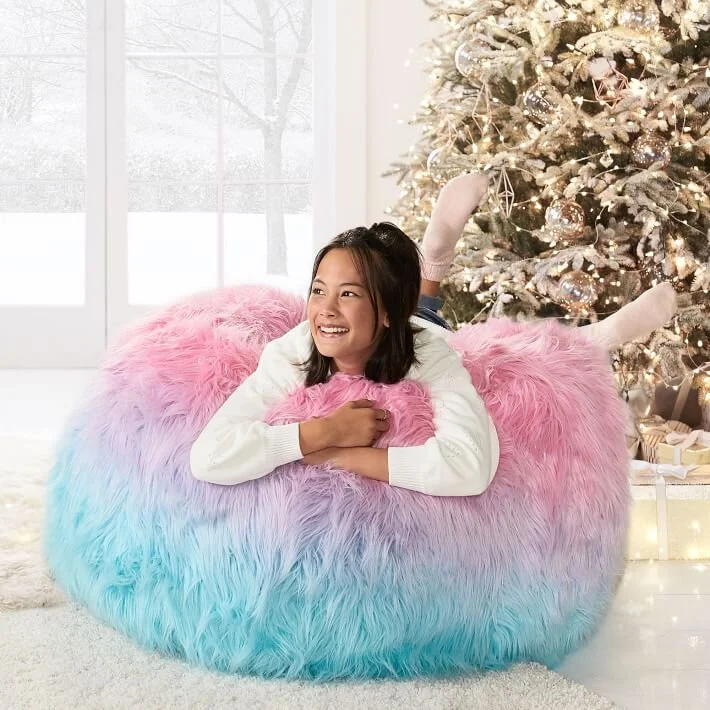  Girl laying on bean bag chair in front of Christmas Tree 