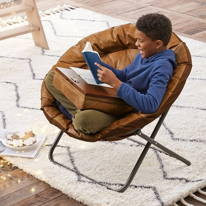 Boy reading a book in a chair 