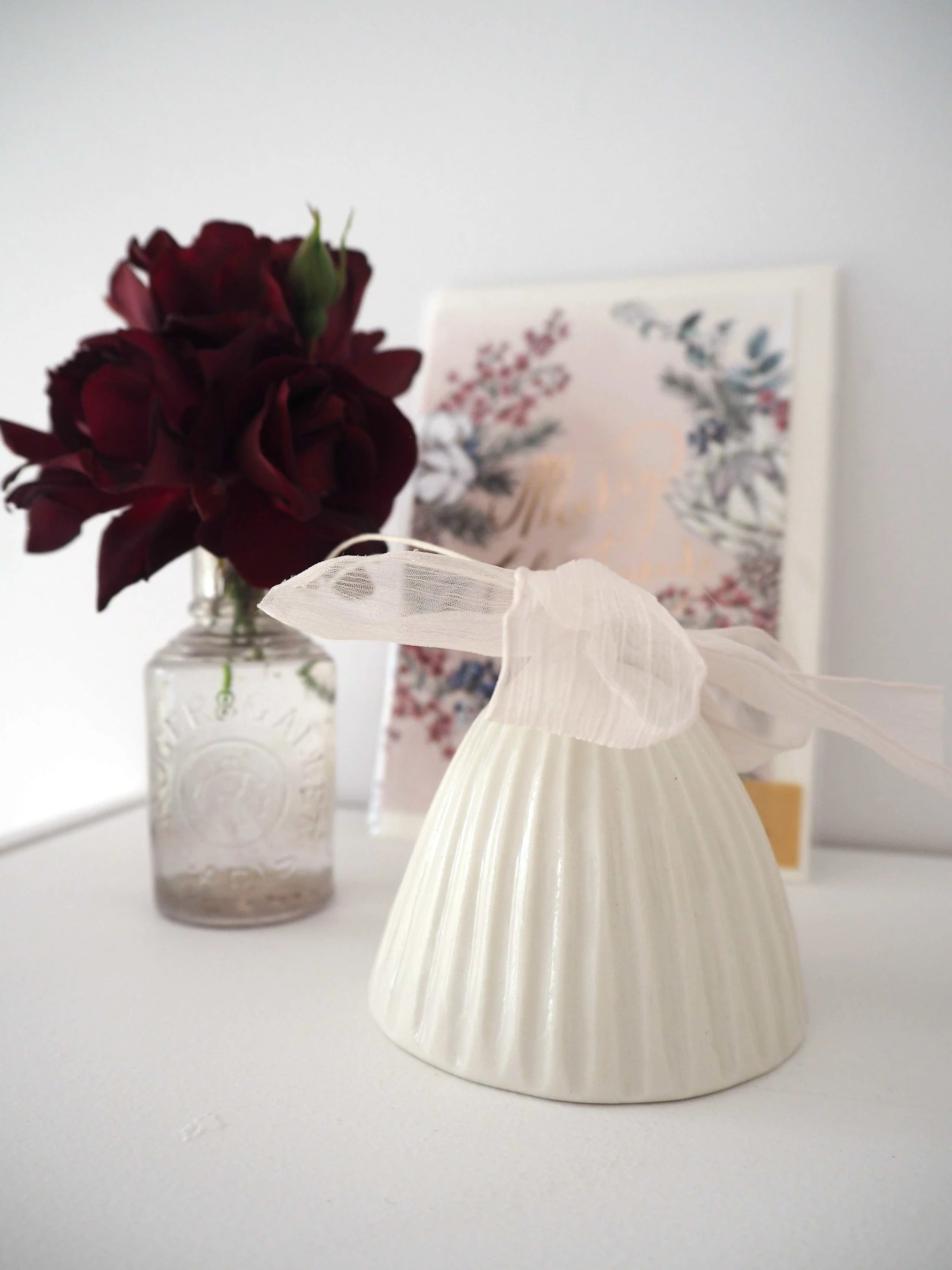 GOST_Lucy Ings_bell carved lines wide white with pink ribbon_low res.jpeg