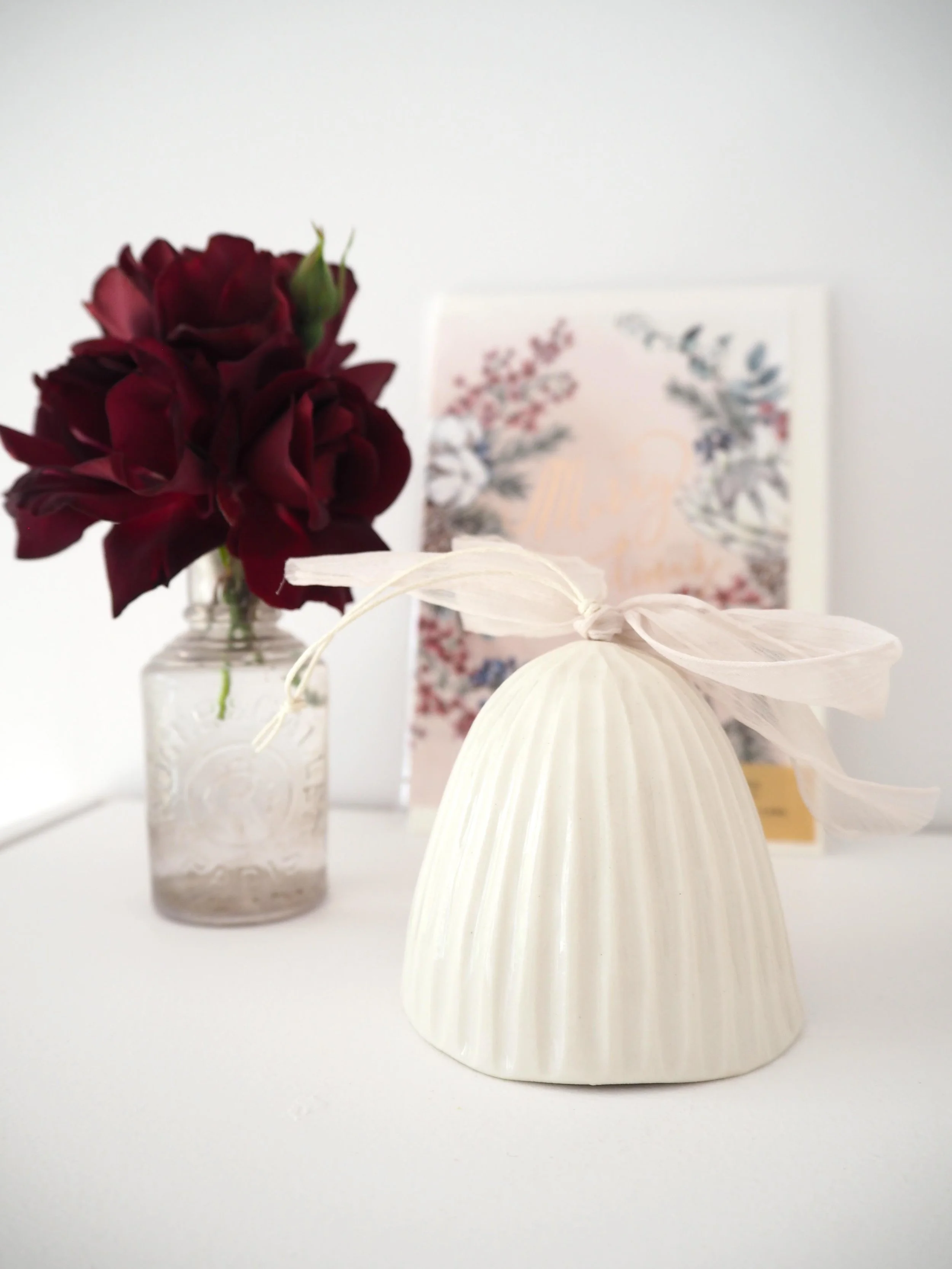 GOST_Lucy Ings_bell carved lines slim base white with pink ribbon_low res.jpeg