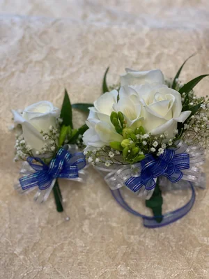 corsage to match royal blue dress This glamorous corsage of baby white roses will match a navy dress