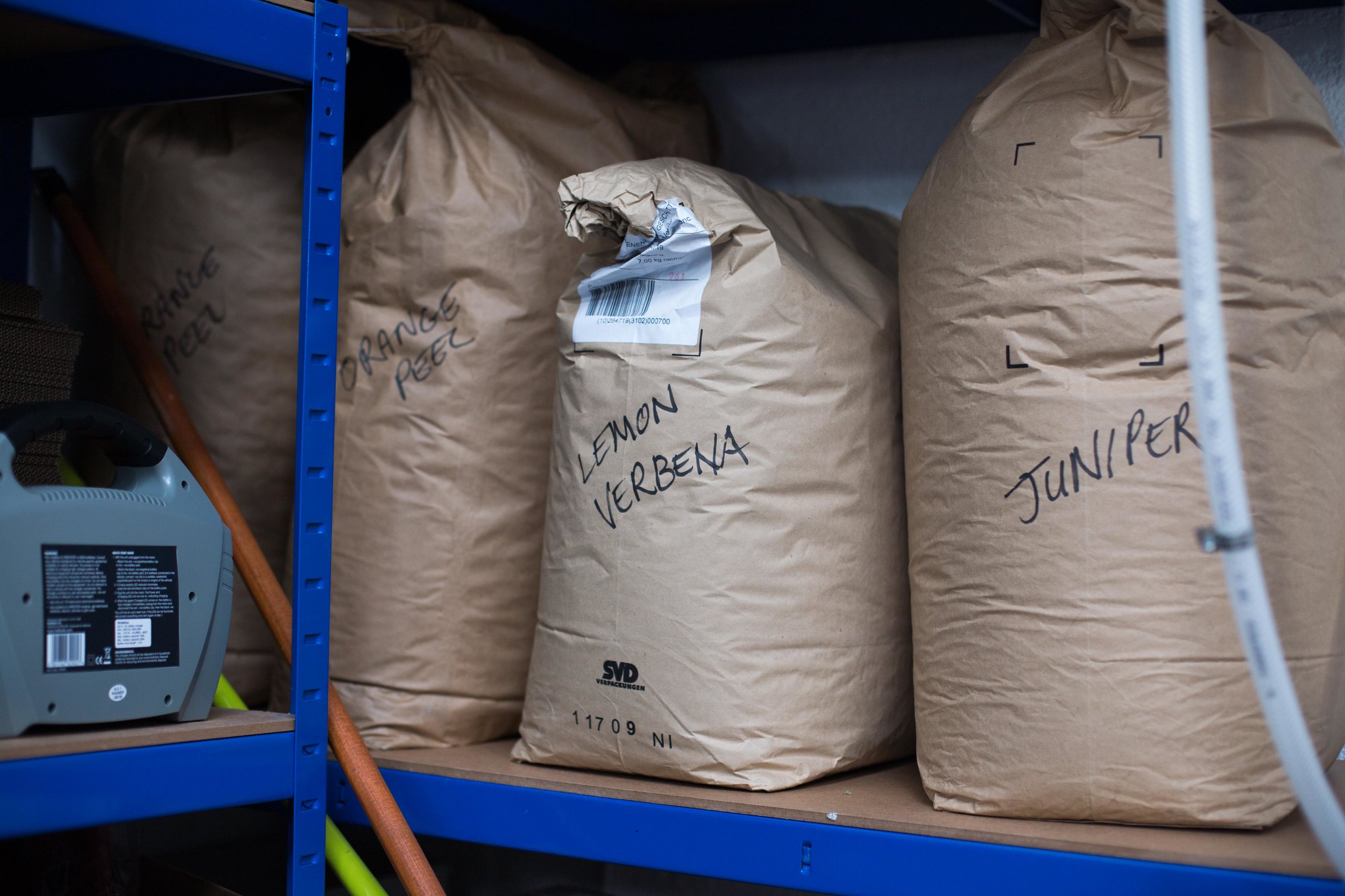  The shelf holding sacks of dry ingredients used to flavour the different gins. 